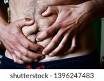 Small photo of skinny stomach under pain, hands over it trying to reduce discomfort