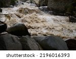 Small photo of High-pressure flood water in mountain river tributary, caused by global warming, melting glaciers, and torrential rains. This has caused devastation in Pakistan With selective focus depth of field.