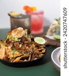 Small photo of Nacho dish is a food from Mexico. In its simplest form, nachos consist of tortilla chips smothered in melted cheese.
