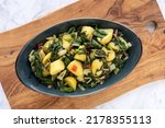 Small photo of Potatoes with swiss chard leaves. South Croatian Blitva dish made with boiled potatoes, swiss chard, garlic and olive oil.