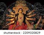 Small photo of Idol of Goddess Devi Durga at a decorated puja pandal in Kolkata, West Bengal, India. Durga Puja is a famous and major religious festival of Hinduism that is celebrated throughout the world.