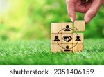 Small photo of Hand arranging wood block stacking as hand shaking icon and human symbol on natural environment background.Business contract, success concept and Agreement deal closure concept.Empathy.