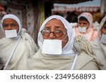 Small photo of HARIDWAR, UTTARAKHAND, INDIA - JANUARY 13, 2010: group of Jain women with traditional white clothing and square face mask