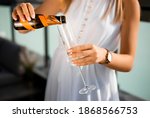 Girl pouring champagne into glass