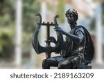 Small photo of Moscow, Russia, Apollo ancient god of poetry and music metal statue on a plain background