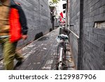 Small photo of Beijing, China - October 18 2017 : a bike is parked against a wall in a back alley of a hutong in downtown Beijing