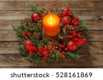 Advent wreath with candle on wooden table. Christmas time.