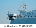 Small photo of Wing of the wheelhouse of the passenger ferry. Cruise ship in the port with a clear sky in the background.