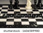 Small photo of The concept of Scrummaster represented by black letter tiles