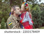 Portrait of a Ukrainian soldier with his little daughter. Long-awaited meeting.