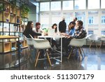 Group of casually dressed businesspeople discussing ideas in the office. Creative professionals gathered at the meeting table for discuss the important issues of the new successful startup project