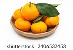 Small photo of Tangerines. Close view on Fresh Mandarin Orange. Mandarin Imperial Ponkam, in woven basket. Green Leaf. Isolated on White Background. Citrus. Sweet an