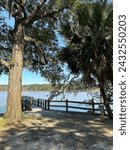 Small photo of View of trees and pier over Tucker Bayou at Eden Gardens State Park Florida
