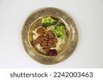 Small photo of venison ragout with ribbon noodles and broccoli nobly served on a plate