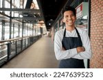 Small photo of young hispanic business owner smile and hold tablet for check order from customer stand isolated on blurred restaurant cafe shop background for SME new small business and franchise investment concept