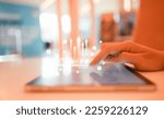 Small photo of close up businessman hand touch screen on digital tablet to use marketing tool and check traffic research of pay per click program on web page for online b2b business and lifestyle concept