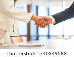 close up investor businessman handshake with partner vendor after completed acquisition ,collaboration of two ceo leader hand shake for make agreement or deal financial cooperative and synergy concept