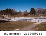 Small photo of LOS ALAMOS, NEW MEXICO - DECEMBER 13, 2013: Ashley Pond, partially iced over, in Manhattan Project National Historic Park.