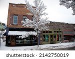 Small photo of FLAGSTAFF, ARIZONA - DECEMBER 20, 2013: Businesses on N San Francisco St include Mountain Sports and Earthbound Trading Co, after a snow storm.