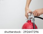 Small photo of motion hand pull the pin of fire extinguisher