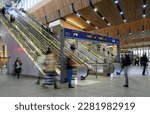 Small photo of London, UK - Mar 22 2023: People in London Bridge railway station with motion blur. Station concourse with escalators to platforms. London Bridge station is a transport hub in Greater London.