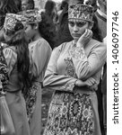 Small photo of Togh/Armenia. September 17, 2016. A dancer girl in traditional armenian dress looking at funambulist during the WineFest-2016.