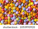 A lot of colorful chocolate candy. Close up top view, occupying the whole picture.