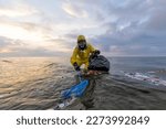 Small photo of Biologist cleans ocean sea from plastic and caps wearing suit and gas mask due to dirty polluted water. Microplastics and nanoplastics from water bottles dangerous for health Inflammation, tumors