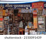 Small photo of DISTRICT VARANASI, UTTAR PRADESH, INDIA - MARCH 25, 2022: An indian famous books store called Geeta pustakalaya, text written in hindi language, hindu religious books shop at varanasi.
