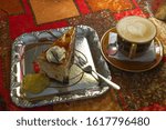 Small photo of Soft focus of a cup of coffee and cake on ventage background.
