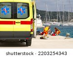 Small photo of ambulance workers provide first aid to a person in a yacht port. heat stroke in the sun.