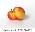 An unusual shaped apple with a double plum on a white background