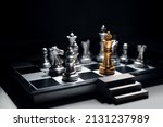 Small photo of Golden king chess surrounded by enemy and checkmate for end game, But he has emergency exit stairs prepare for worst case scenario. Business strategy and life planning concept.