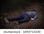 Small photo of A caucasian man's dead body was found in the park. Murder in the woods. Murdered citizen. Crime scene