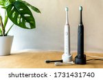 Modern rechargeable sonic or electric toothbrush set with charger in bathroom. Concept of professional oral care and healthy teeth by using ultrasonic smart toothbrush. Minimal design