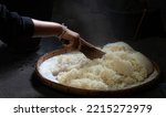 Small photo of Steaming glutinous rice and spreading the steam and heat when the rice is cooked, retro or old style. And there was a gush of steam rising up. Cooking in a rural kitchen, Thailand