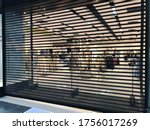black shutted iron gates of shop in shopping mall due to restrictions of lockdown. Protection measures against coronavirus pandemic. Preparation for opening after ending of lockdown.