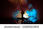 Small photo of young beautiful couple smoking a hookah in the smoke in ultraviolet and bardic light