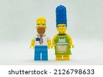 Small photo of Quezon City, Philippines - February 20, 2022: Lego Simpsons Minifigure Homer and Marge Simpson Posing together as a couple (landscape)