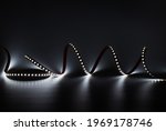 LED strip with white lighting on a dark decorative background