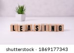 Small photo of Money bag and blocks with the word Leasing. A lease is a contractual arrangement calling for the lessee to pay the lessor for use of an asset. Property, vehicles are common assets that are leased