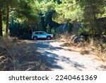 Small photo of Vacation with a rental car. 4x4 off-road Jeep Renegade on dirt road on Rhodes island, Greece. October 09, 2022
