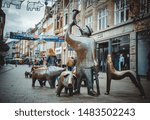 Small photo of Bremen, Germany, October 3, 2018 'Swineherd and his flock' sculpture in the central Bremen on background of old city buildings
