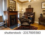 Small photo of Mentor, Ohio -May 1, 2023: James A Garfield National Historic Site. Lawnfield home Snuggery, President James Garfield's study or den. Williams College classmates, reading chair, In Memoriam fireplace