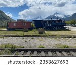 Small photo of Skagway, Alaska -June 1, 2023: White Pass and Yukon Route, Canadian and U.S. Class III narrow-gauge railroad links Skagway with Whitehorse, Yukon. Steam locomotive, caboose and track. Engine 52.