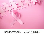 Small photo of Sweet pink ribbon shape with girl paper doll on pink background for Breast Cancer Awareness symbol to promote in october month campaign