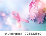 Small photo of Sweet pink ribbon shape with girl paper doll on blue background for Breast Cancer Awareness symbol to promote in october month campaign