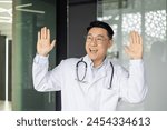 A joyful mature asian doctor...
