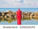 Small photo of An improbable hydrant at the seaside - Plenty of water concept image