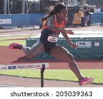 Small photo of Eugene, Oregon June 12, 2014 - Jesica Ejesieme of the Univeristy of Illinois clears a hurdle in a preliminary heat of the women's 400m race at the 2014 NCAA Track & Field Championships